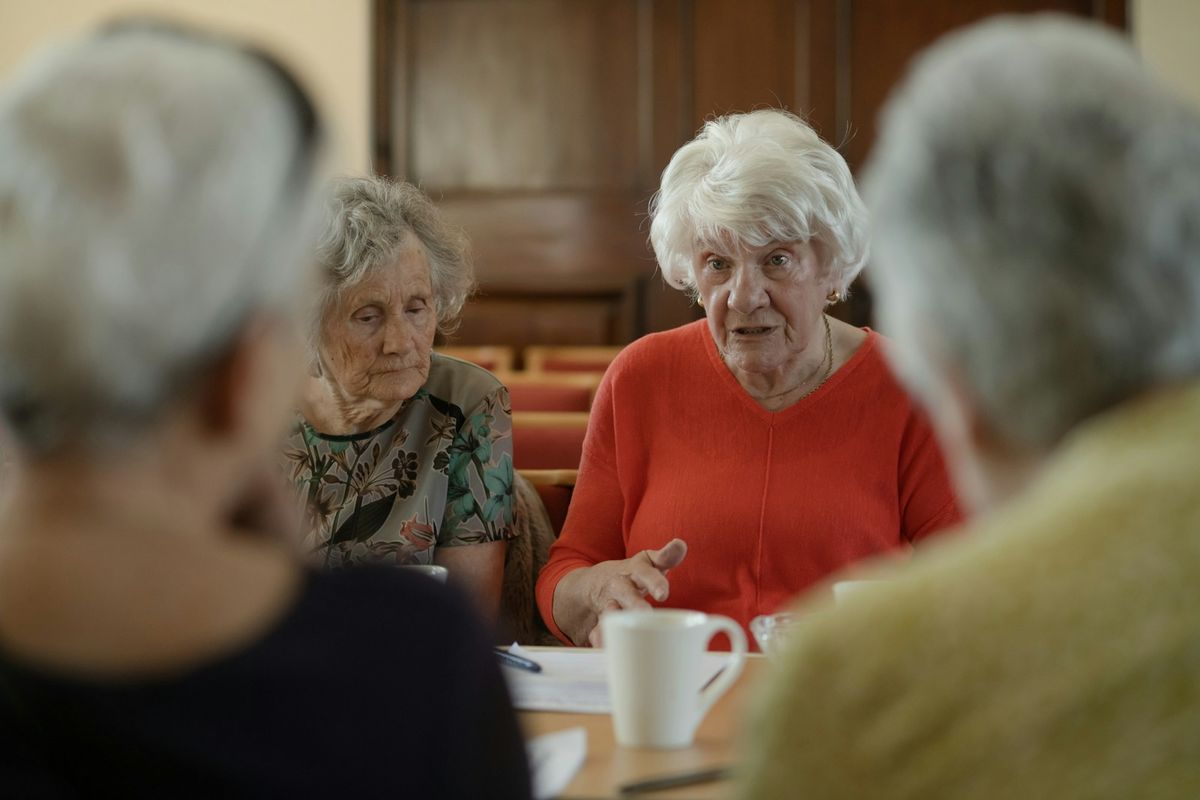 Older women sitting around a table talking